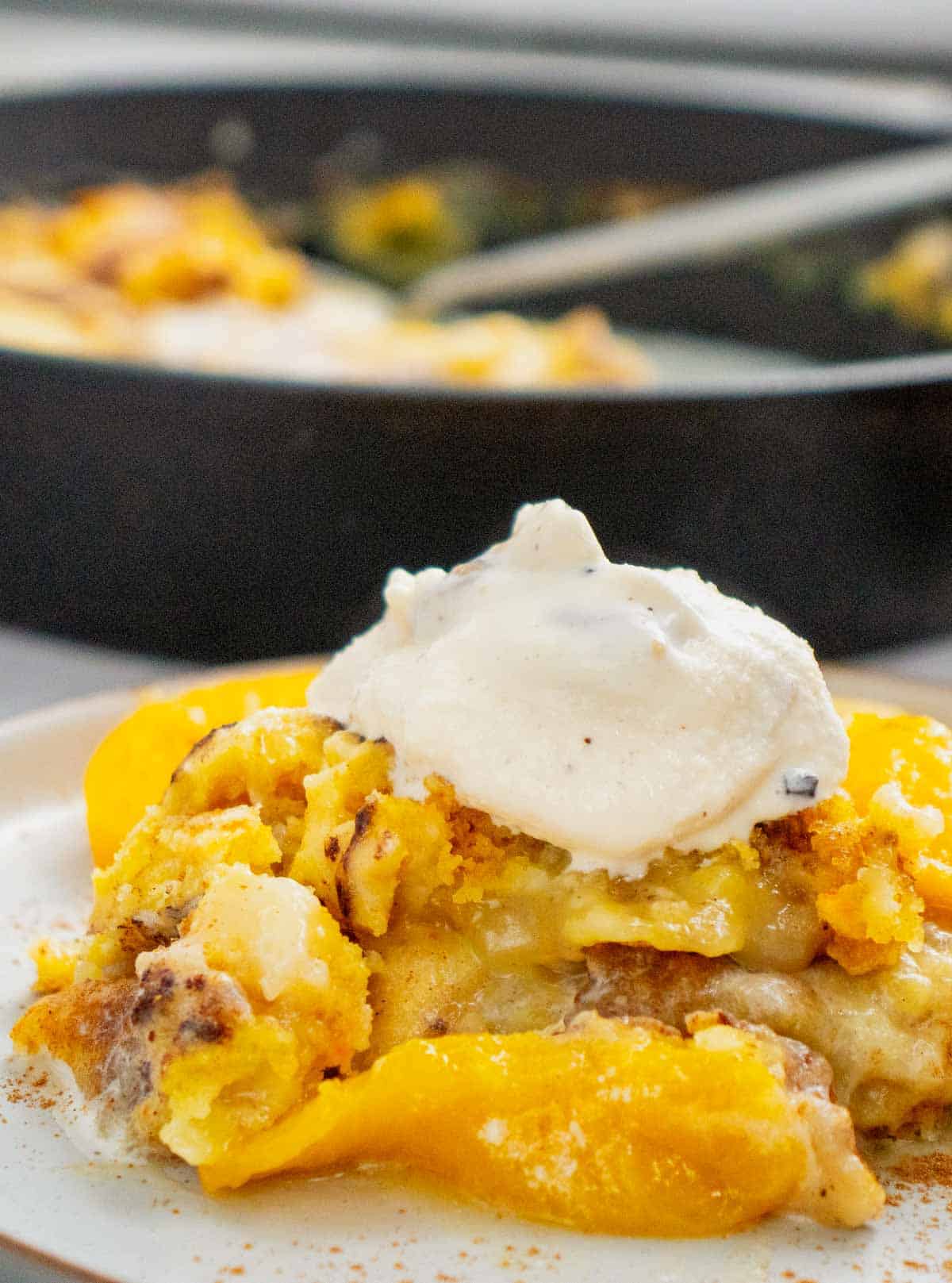 This Skillet Peach Dump Cake is the ultimate easy dessert recipe for peach lovers. Made with canned peaches or fresh peaches, yellow cake mix, butter, and cinnamon, this Peach Dump Cake Recipe comes together with minimal prep and bakes to golden perfection in a cast iron skillet. If you're searching for Easy Peach Desserts, Peach Dessert Recipes, Dump Cake Recipes, Peach Cobbler Dump Cake, Cast Iron Skillet Desserts, Summer Peach Recipes, Fresh Peach Desserts, or Quick Family Desserts, this recipe is a must-try. Perfect for potlucks, BBQs, holidays, weeknight treats, and summer gatherings, this warm and buttery dessert tastes amazing topped with vanilla ice cream or whipped cream. Save this Easy Peach Dump Cake for your next simple homemade dessert.