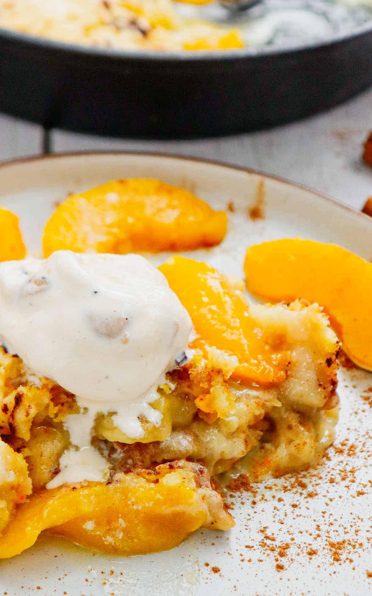 This Skillet Peach Dump Cake is the ultimate easy dessert recipe for peach lovers. Made with canned peaches or fresh peaches, yellow cake mix, butter, and cinnamon, this Peach Dump Cake Recipe comes together with minimal prep and bakes to golden perfection in a cast iron skillet. If you're searching for Easy Peach Desserts, Peach Dessert Recipes, Dump Cake Recipes, Peach Cobbler Dump Cake, Cast Iron Skillet Desserts, Summer Peach Recipes, Fresh Peach Desserts, or Quick Family Desserts, this recipe is a must-try. Perfect for potlucks, BBQs, holidays, weeknight treats, and summer gatherings, this warm and buttery dessert tastes amazing topped with vanilla ice cream or whipped cream. Save this Easy Peach Dump Cake for your next simple homemade dessert.
