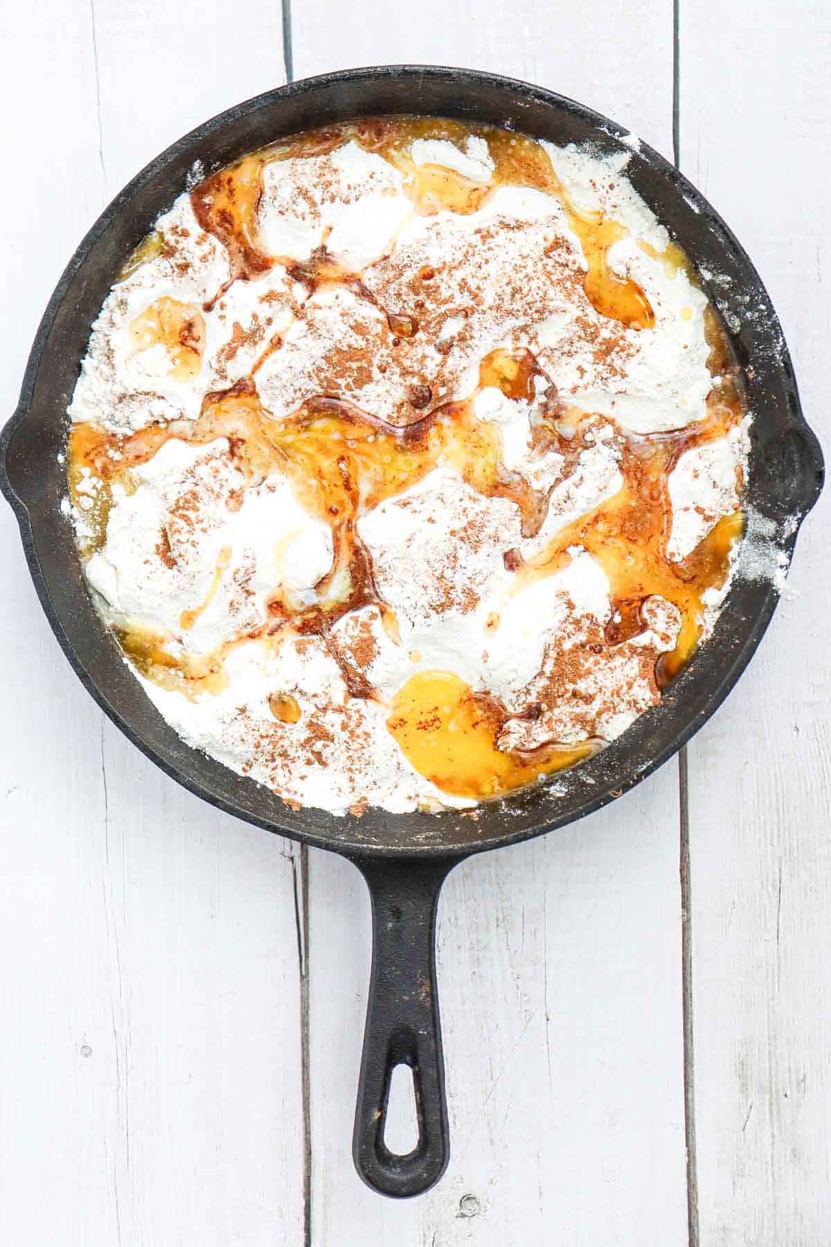melted butter poured over the ingredients in the skillet