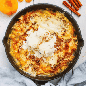 This Skillet Peach Dump Cake is the ultimate easy dessert recipe for peach lovers. Made with canned peaches or fresh peaches, yellow cake mix, butter, and cinnamon, this Peach Dump Cake Recipe comes together with minimal prep and bakes to golden perfection in a cast iron skillet. If you're searching for Easy Peach Desserts, Peach Dessert Recipes, Dump Cake Recipes, Peach Cobbler Dump Cake, Cast Iron Skillet Desserts, Summer Peach Recipes, Fresh Peach Desserts, or Quick Family Desserts, this recipe is a must-try. Perfect for potlucks, BBQs, holidays, weeknight treats, and summer gatherings, this warm and buttery dessert tastes amazing topped with vanilla ice cream or whipped cream. Save this Easy Peach Dump Cake for your next simple homemade dessert.