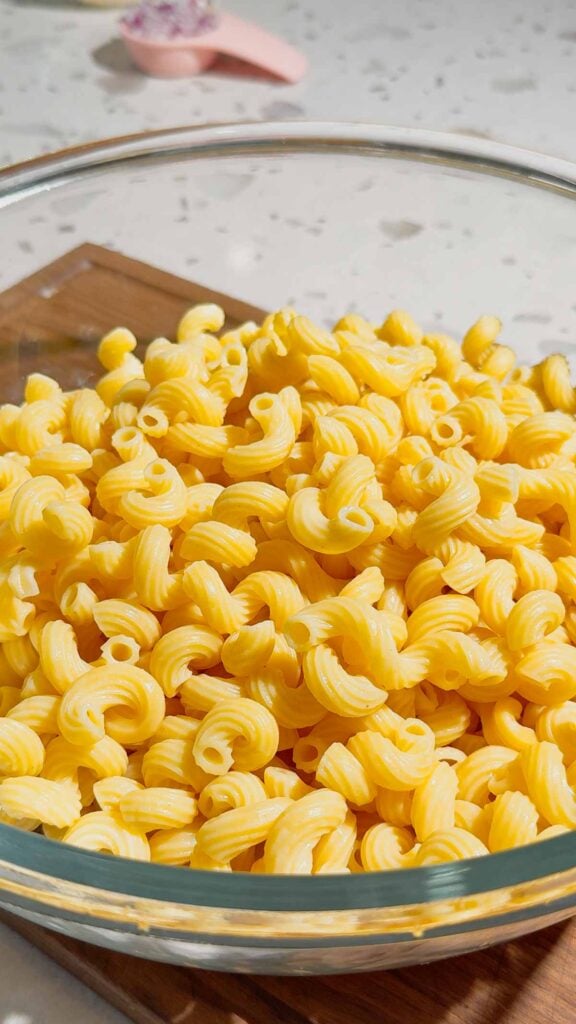 cooked cavatappi noodles in a glass mixing bowl