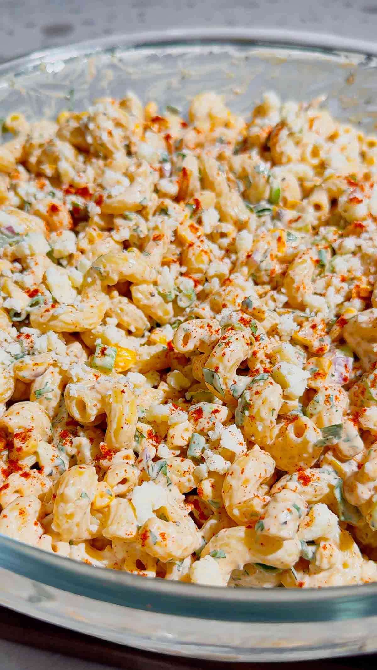 This Street Corn Pasta Salad is the ultimate Summer Pasta Salad for BBQs, potlucks, cookouts, and family gatherings. Made with tender cavatappi pasta, roasted corn, cotija cheese, red onion, green onions, fresh cilantro, and a creamy lime dressing, this Mexican Street Corn Pasta Salad is packed with bold flavor in every bite. If you're searching for Easy Pasta Salad Recipes, Corn Pasta Salad, Mexican Pasta Salad, Cold Pasta Salad Recipes, or Summer Side Dishes, this recipe is a must-try. Perfect for Backyard BBQ Food Ideas, Picnic Side Dishes, Potluck Recipes, and Make Ahead Salads, it comes together with simple ingredients and is always a crowd favorite. Serve this Street Corn Salad Recipe alongside grilled chicken, burgers, steak, or tacos for an easy and delicious summer meal everyone will love.