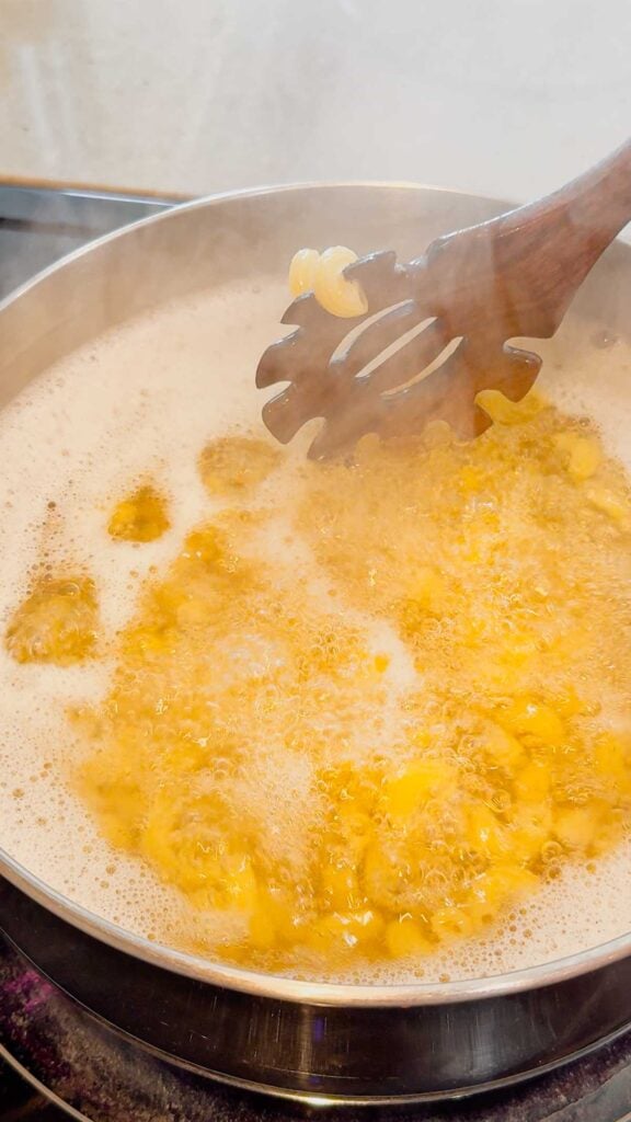 cavatappi noodles cooking in a pot of boiling water