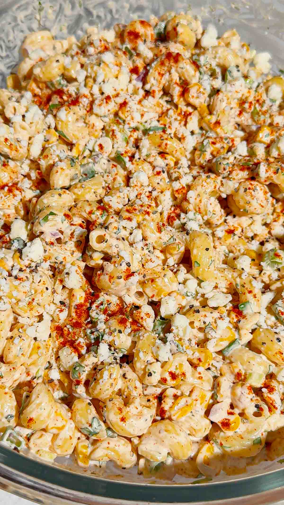 This Street Corn Pasta Salad is the ultimate Summer Pasta Salad for BBQs, potlucks, cookouts, and family gatherings. Made with tender cavatappi pasta, roasted corn, cotija cheese, red onion, green onions, fresh cilantro, and a creamy lime dressing, this Mexican Street Corn Pasta Salad is packed with bold flavor in every bite. If you're searching for Easy Pasta Salad Recipes, Corn Pasta Salad, Mexican Pasta Salad, Cold Pasta Salad Recipes, or Summer Side Dishes, this recipe is a must-try. Perfect for Backyard BBQ Food Ideas, Picnic Side Dishes, Potluck Recipes, and Make Ahead Salads, it comes together with simple ingredients and is always a crowd favorite. Serve this Street Corn Salad Recipe alongside grilled chicken, burgers, steak, or tacos for an easy and delicious summer meal everyone will love.