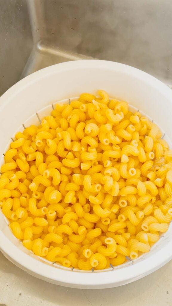 cooked cavatappi noodles in a strainer