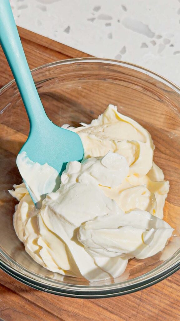 sour cream and mayo in a glass mixing bowl