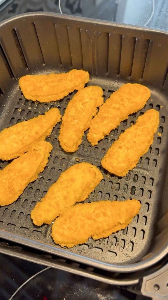 frozen chicken fingers in an air fryer basket