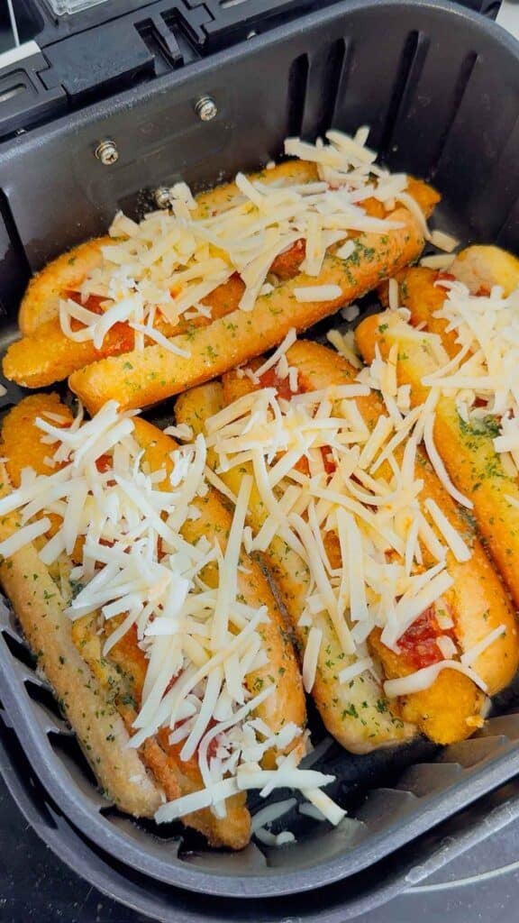 shredded cheese on top of crispy chicken subs