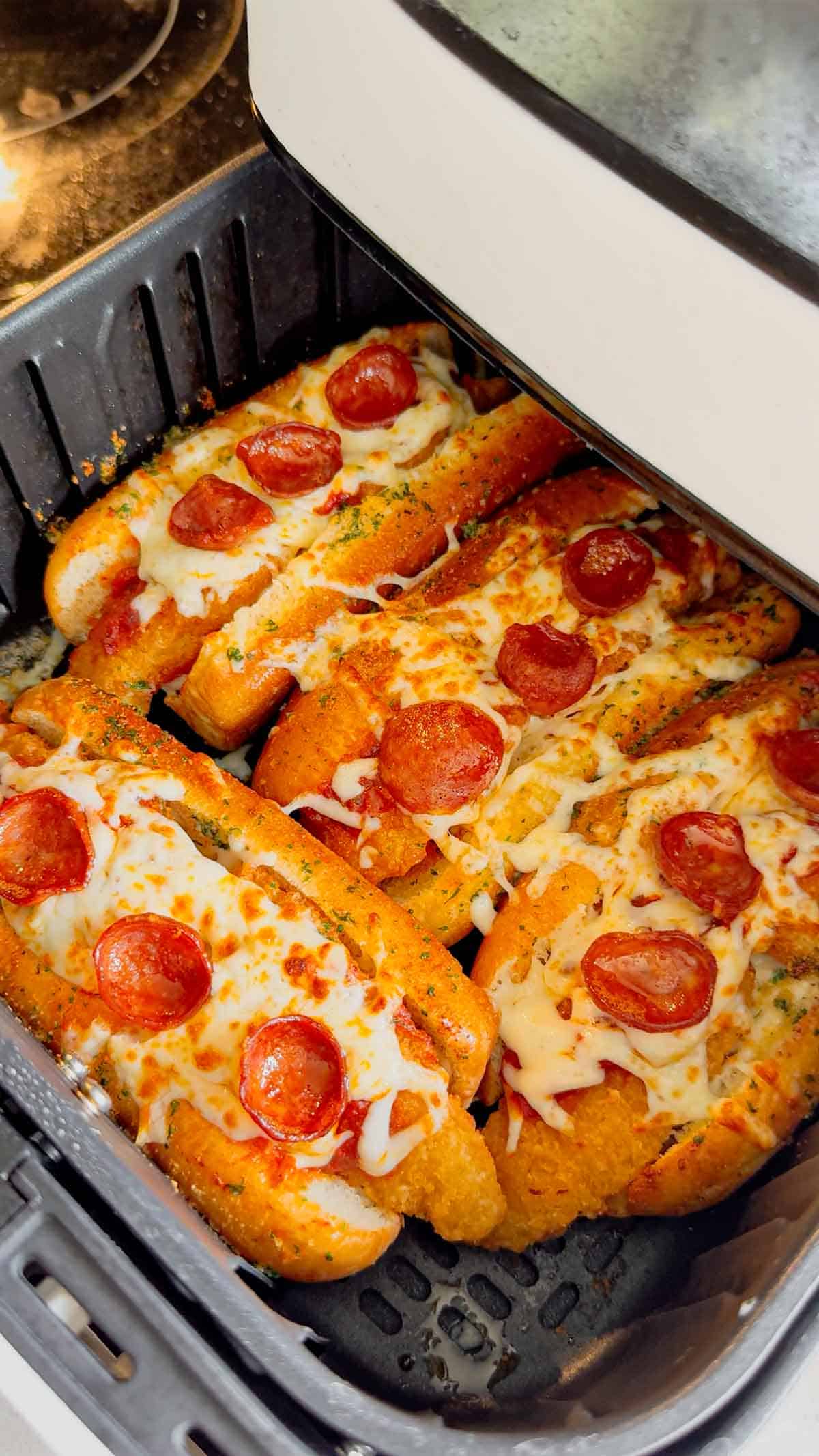 Looking for an easy air fryer dinner everyone will devour? These Air Fryer Crispy Chicken Pizza Subs combine crispy chicken tenders, pepperoni, pizza sauce, gooey mozzarella, and buttery garlic buns for the ultimate handheld meal. Perfect for air fryer recipes, easy weeknight dinners, kid friendly dinners, pizza sandwiches, chicken sub recipes, hot dog bun recipes, quick family meals, game day food, easy lunch ideas, and comfort food recipes. This simple recipe uses frozen chicken tenders for a fast dinner that's packed with pizza flavor and ready in minutes. Save this easy air fryer recipe for busy nights, party food, after-school meals, or whenever you're craving a cheesy, crispy pizza-inspired sandwich the whole family will love!