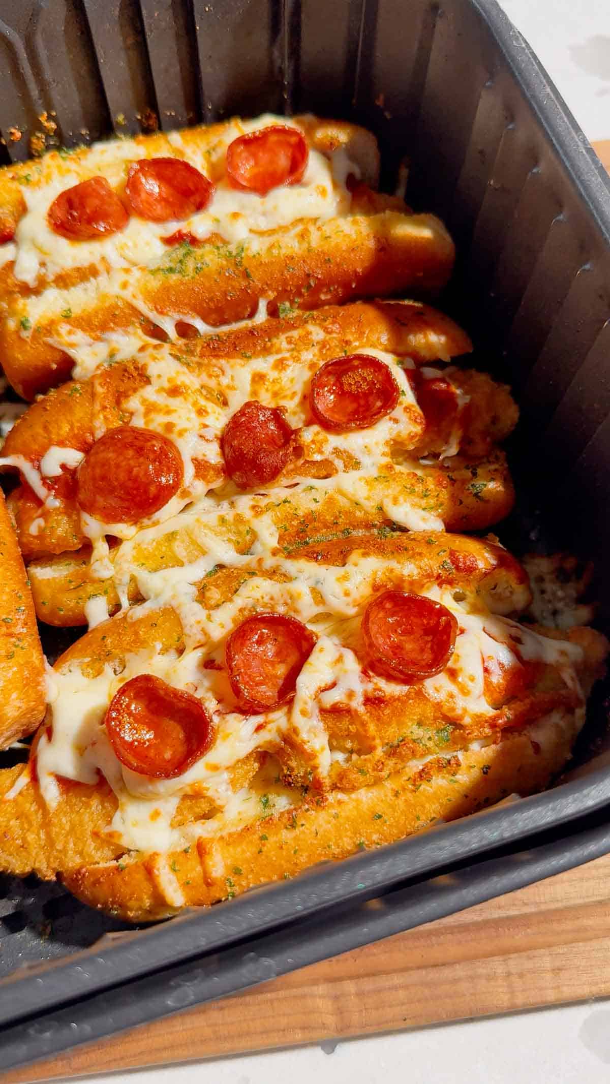 Looking for an easy air fryer dinner everyone will devour? These Air Fryer Crispy Chicken Pizza Subs combine crispy chicken tenders, pepperoni, pizza sauce, gooey mozzarella, and buttery garlic buns for the ultimate handheld meal. Perfect for air fryer recipes, easy weeknight dinners, kid friendly dinners, pizza sandwiches, chicken sub recipes, hot dog bun recipes, quick family meals, game day food, easy lunch ideas, and comfort food recipes. This simple recipe uses frozen chicken tenders for a fast dinner that's packed with pizza flavor and ready in minutes. Save this easy air fryer recipe for busy nights, party food, after-school meals, or whenever you're craving a cheesy, crispy pizza-inspired sandwich the whole family will love!