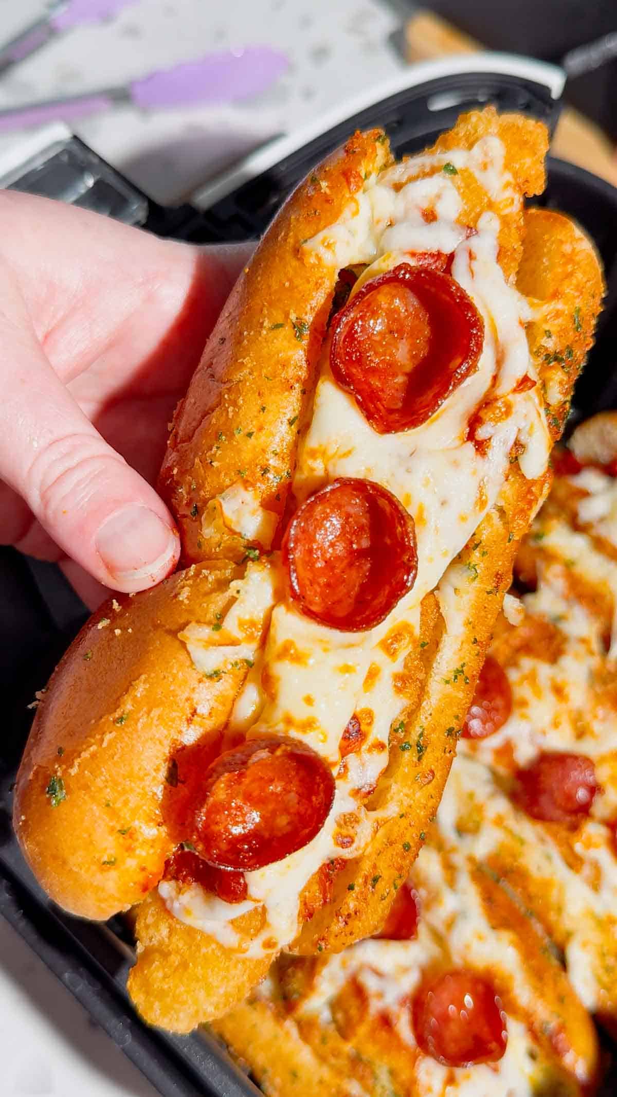 Looking for an easy air fryer dinner everyone will devour? These Air Fryer Crispy Chicken Pizza Subs combine crispy chicken tenders, pepperoni, pizza sauce, gooey mozzarella, and buttery garlic buns for the ultimate handheld meal. Perfect for air fryer recipes, easy weeknight dinners, kid friendly dinners, pizza sandwiches, chicken sub recipes, hot dog bun recipes, quick family meals, game day food, easy lunch ideas, and comfort food recipes. This simple recipe uses frozen chicken tenders for a fast dinner that's packed with pizza flavor and ready in minutes. Save this easy air fryer recipe for busy nights, party food, after-school meals, or whenever you're craving a cheesy, crispy pizza-inspired sandwich the whole family will love!