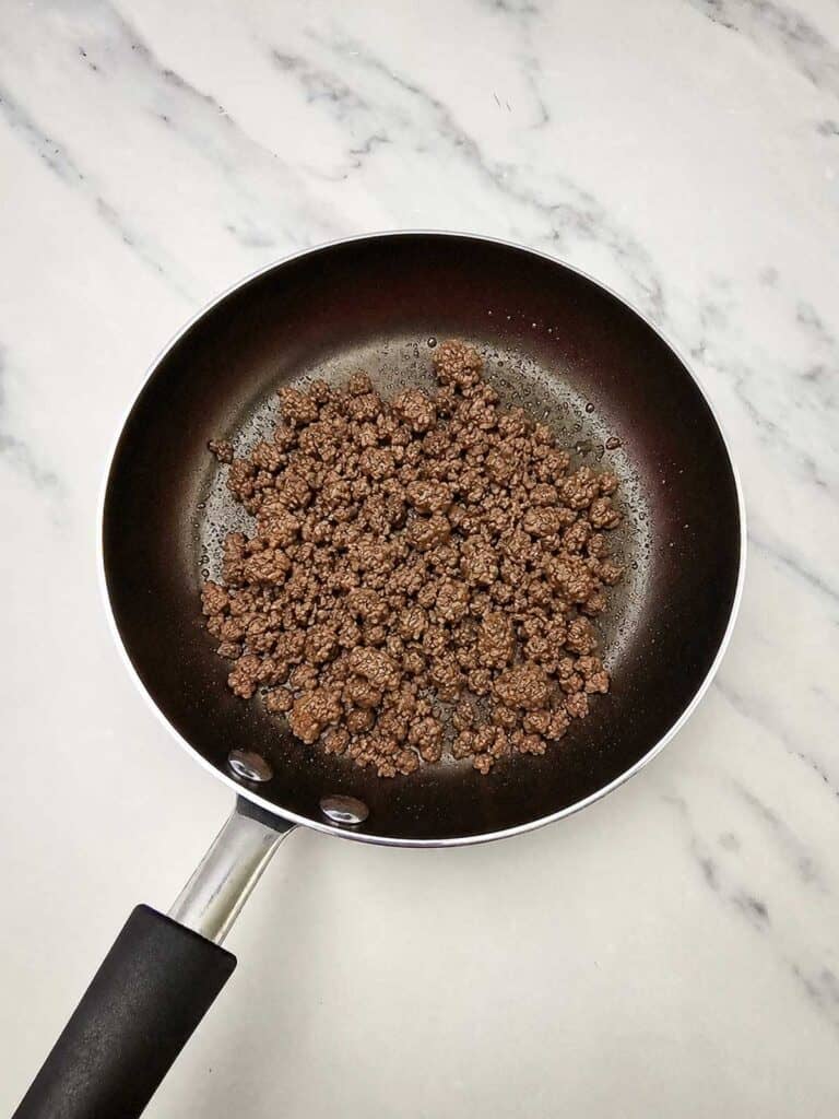 cooked ground beef in small skillet