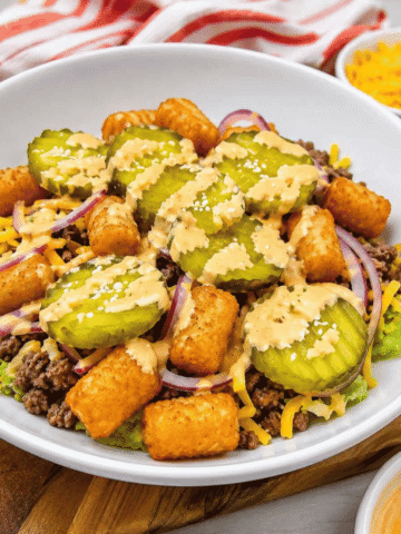 Craving all the flavors of your favorite fast food burger without the bun? This Big Mac Bowl is loaded with seasoned ground beef, crispy tater tots, shredded lettuce, cheddar cheese, red onion, pickles, sesame seeds, and a creamy special sauce for an easy meal the whole family will love. If you're looking for Big Mac Bowl Recipe, Burger Bowl Recipe, Cheeseburger Bowl, Low Carb Big Mac Bowl, Big Mac Salad Bowl, Ground Beef Dinner Ideas, Easy Ground Beef Recipes, Big Mac Casserole Inspiration, Burger Salad Recipe, or Quick Weeknight Dinners, this simple recipe is packed with classic burger flavor, comes together in under 20 minutes, and is perfect for busy nights, meal prep, or an easy comfort food dinner everyone will request again and again.