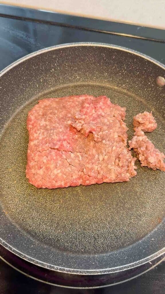 raw ground beef in a skillet