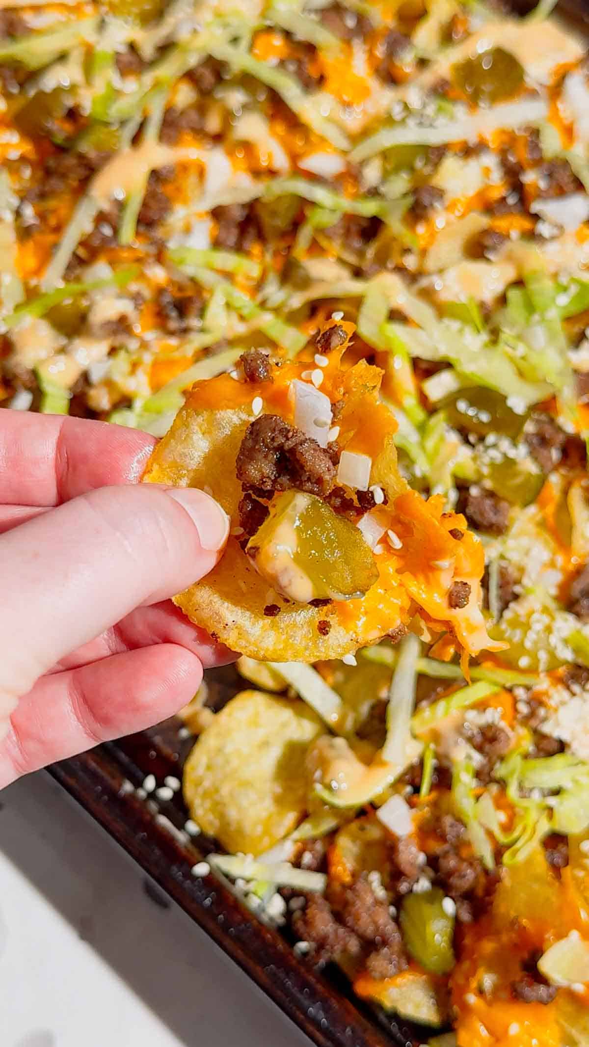 Looking for the ultimate game day snack or easy party appetizer? These Big Mac Nachos combine all the iconic flavors of your favorite cheeseburger with crispy kettle cooked potato chips for an unforgettable crowd-pleasing recipe. Loaded with seasoned ground beef, melted cheddar cheese, pickles, onions, shredded lettuce, Thousand Island dressing, and sesame seeds, these cheeseburger nachos are perfect for football parties, tailgates, family movie nights, and quick weeknight dinners. If you love loaded nachos, burger recipes, Big Mac-inspired recipes, easy appetizers, sheet pan snacks, comfort food, and fun party food ideas, this simple recipe belongs on your menu. Save this easy Big Mac Nachos recipe for your next game day spread, potluck, or casual family gathering!