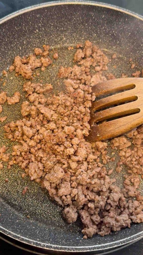 cooked and seasoned ground beef in a skillet