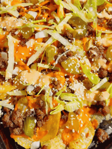 Looking for the ultimate game day snack or easy party appetizer? These Big Mac Nachos combine all the iconic flavors of your favorite cheeseburger with crispy kettle cooked potato chips for an unforgettable crowd-pleasing recipe. Loaded with seasoned ground beef, melted cheddar cheese, pickles, onions, shredded lettuce, Thousand Island dressing, and sesame seeds, these cheeseburger nachos are perfect for football parties, tailgates, family movie nights, and quick weeknight dinners. If you love loaded nachos, burger recipes, Big Mac-inspired recipes, easy appetizers, sheet pan snacks, comfort food, and fun party food ideas, this simple recipe belongs on your menu. Save this easy Big Mac Nachos recipe for your next game day spread, potluck, or casual family gathering!