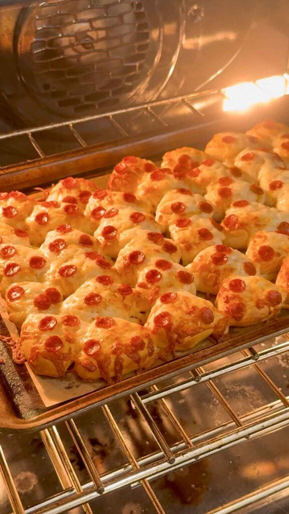 pizza biscuit bites on a baking sheet in the oven