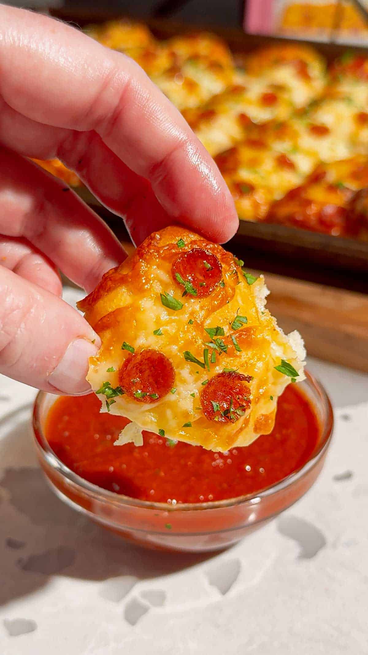 Looking for an easy pizza appetizer everyone will love? These Biscuit Pizza Bites are the perfect bite-sized snack made with refrigerated biscuit dough, mozzarella cheese, mini pepperoni, garlic butter, and fresh parsley. They're crispy, cheesy, buttery, and ready in under 30 minutes, making them ideal for easy appetizer recipes, game day snacks, party food ideas, after school snacks, quick dinner ideas, kid friendly meals, and finger food recipes. Serve them with pizza sauce, ranch, or garlic dipping sauce for the ultimate crowd-pleasing treat. Whether you're planning a family movie night, holiday party, football gathering, or need a simple weeknight recipe, these homemade pizza bites are guaranteed to disappear fast. Save this easy pizza snack recipe for your next party, potluck, or busy weeknight dinner!