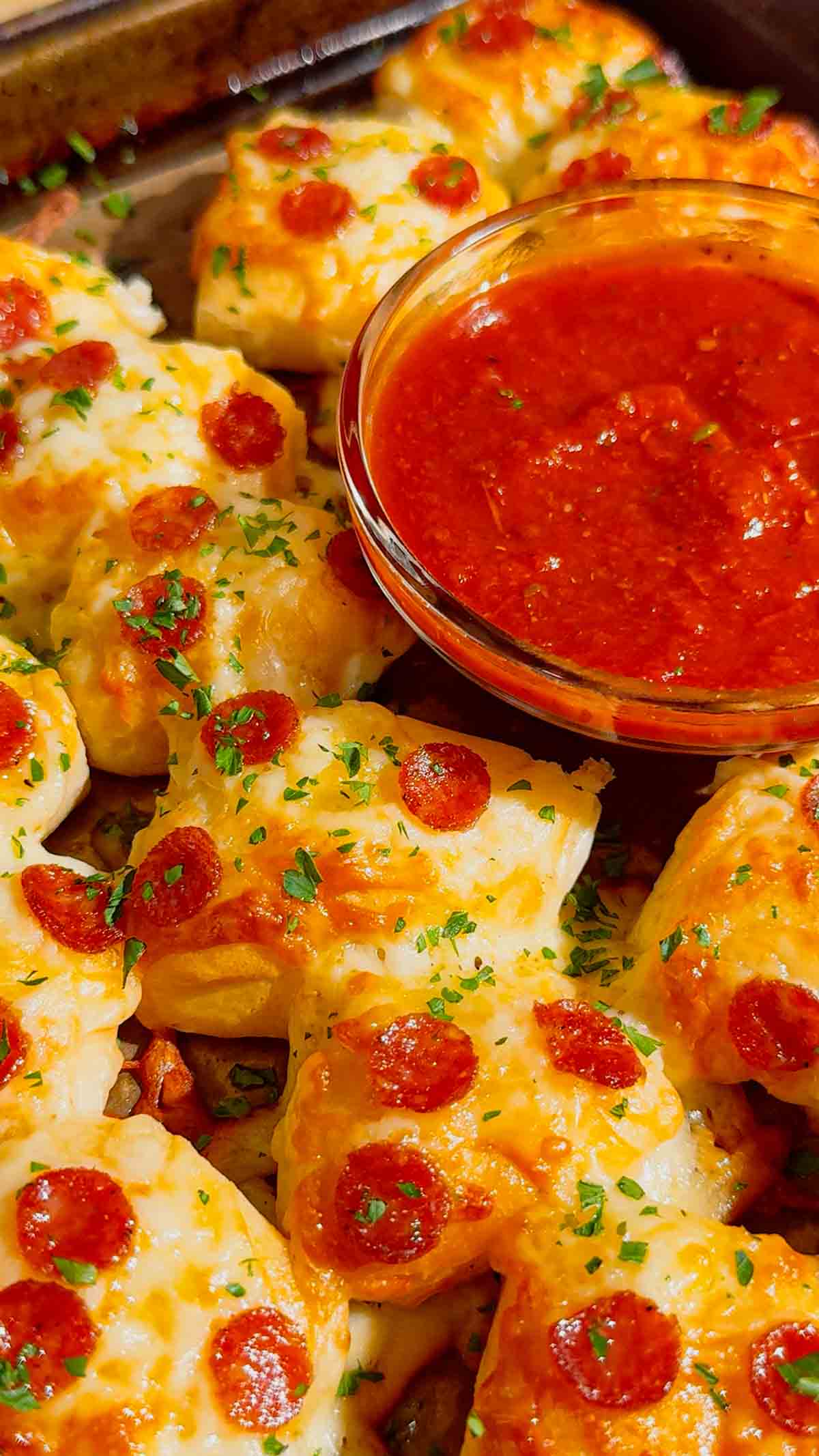 Looking for an easy pizza appetizer everyone will love? These Biscuit Pizza Bites are the perfect bite-sized snack made with refrigerated biscuit dough, mozzarella cheese, mini pepperoni, garlic butter, and fresh parsley. They're crispy, cheesy, buttery, and ready in under 30 minutes, making them ideal for easy appetizer recipes, game day snacks, party food ideas, after school snacks, quick dinner ideas, kid friendly meals, and finger food recipes. Serve them with pizza sauce, ranch, or garlic dipping sauce for the ultimate crowd-pleasing treat. Whether you're planning a family movie night, holiday party, football gathering, or need a simple weeknight recipe, these homemade pizza bites are guaranteed to disappear fast. Save this easy pizza snack recipe for your next party, potluck, or busy weeknight dinner!