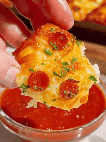 Looking for an easy pizza appetizer everyone will love? These Biscuit Pizza Bites are the perfect bite-sized snack made with refrigerated biscuit dough, mozzarella cheese, mini pepperoni, garlic butter, and fresh parsley. They're crispy, cheesy, buttery, and ready in under 30 minutes, making them ideal for easy appetizer recipes, game day snacks, party food ideas, after school snacks, quick dinner ideas, kid friendly meals, and finger food recipes. Serve them with pizza sauce, ranch, or garlic dipping sauce for the ultimate crowd-pleasing treat. Whether you're planning a family movie night, holiday party, football gathering, or need a simple weeknight recipe, these homemade pizza bites are guaranteed to disappear fast. Save this easy pizza snack recipe for your next party, potluck, or busy weeknight dinner!