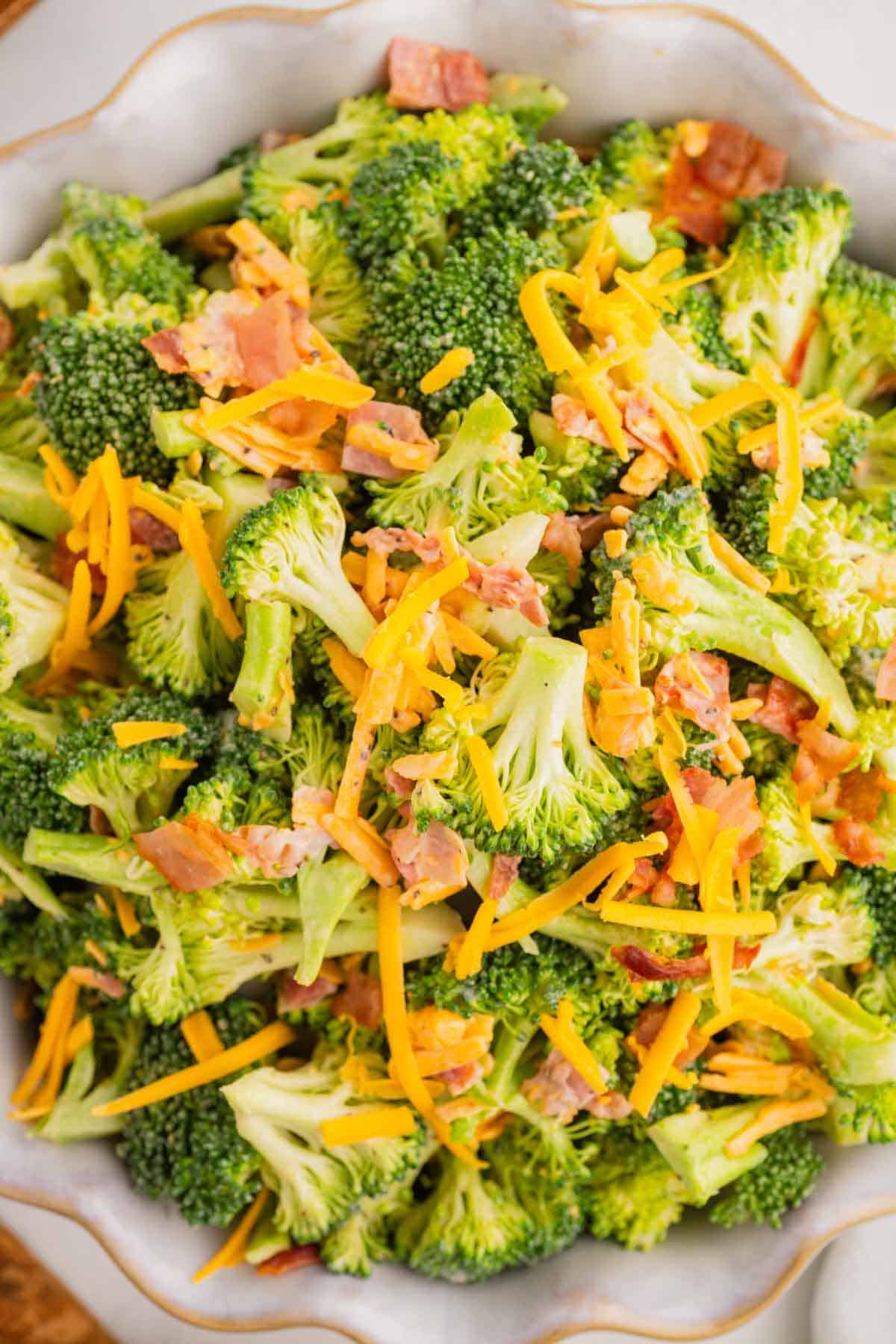 Love the famous Chicken Salad Chick Broccoli Salad? This easy copycat recipe delivers the same crunchy, creamy, tangy flavor at home with fresh broccoli, sharp cheddar cheese, smoky bacon, mayonnaise, and red wine vinegar. Perfect for BBQs, potlucks, picnics, holiday gatherings, meal prep, and easy family dinners, this Broccoli Salad Recipe comes together in just 10 minutes and tastes even better after chilling. If you're searching for the best Copycat Chicken Salad Chick Broccoli Salad, Easy Broccoli Salad Recipe, Creamy Broccoli Salad With Bacon, Broccoli Salad With Cheddar Cheese, or a classic cold side dish everyone will love, this simple recipe is guaranteed to become a favorite all year long. Save this delicious broccoli salad for your next gathering!
