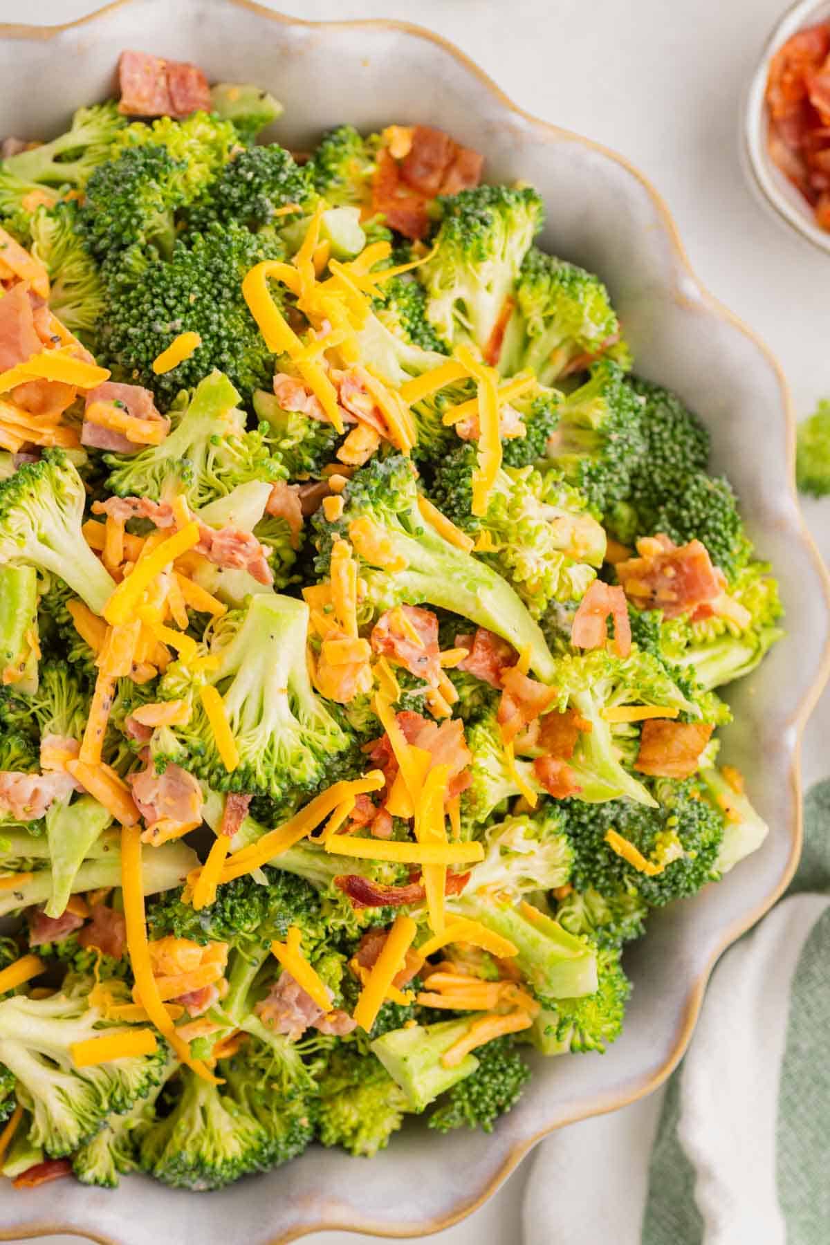 Love the famous Chicken Salad Chick Broccoli Salad? This easy copycat recipe delivers the same crunchy, creamy, tangy flavor at home with fresh broccoli, sharp cheddar cheese, smoky bacon, mayonnaise, and red wine vinegar. Perfect for BBQs, potlucks, picnics, holiday gatherings, meal prep, and easy family dinners, this Broccoli Salad Recipe comes together in just 10 minutes and tastes even better after chilling. If you're searching for the best Copycat Chicken Salad Chick Broccoli Salad, Easy Broccoli Salad Recipe, Creamy Broccoli Salad With Bacon, Broccoli Salad With Cheddar Cheese, or a classic cold side dish everyone will love, this simple recipe is guaranteed to become a favorite all year long. Save this delicious broccoli salad for your next gathering!