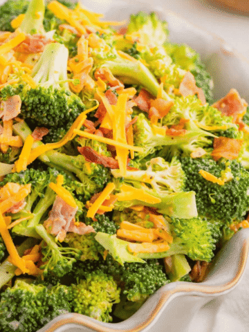 Love the famous Chicken Salad Chick Broccoli Salad? This easy copycat recipe delivers the same crunchy, creamy, tangy flavor at home with fresh broccoli, sharp cheddar cheese, smoky bacon, mayonnaise, and red wine vinegar. Perfect for BBQs, potlucks, picnics, holiday gatherings, meal prep, and easy family dinners, this Broccoli Salad Recipe comes together in just 10 minutes and tastes even better after chilling. If you're searching for the best Copycat Chicken Salad Chick Broccoli Salad, Easy Broccoli Salad Recipe, Creamy Broccoli Salad With Bacon, Broccoli Salad With Cheddar Cheese, or a classic cold side dish everyone will love, this simple recipe is guaranteed to become a favorite all year long. Save this delicious broccoli salad for your next gathering!