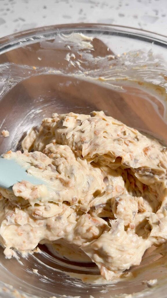 stirring chopped butterfingers into cream cheese mixture with a rubber spatula