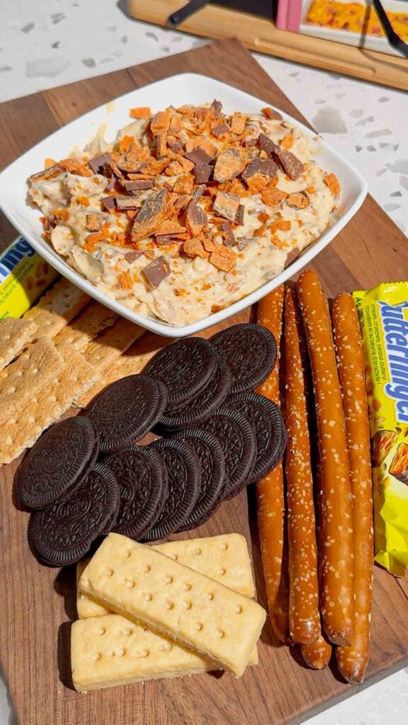 If you're looking for the ultimate no bake dessert, this Butterfinger Dip is about to become your new favorite sweet treat. Made with cream cheese, butter, brown sugar, vanilla, and plenty of chopped Butterfinger candy bars, this creamy dessert dip is perfect for parties, game day, holidays, movie nights, and potlucks. Serve it with graham crackers, vanilla wafers, pretzels, apple slices, strawberries, or cookies for an easy crowd-pleasing snack. This easy dessert dip recipe takes just 10 minutes to make with no baking required, making it ideal for last-minute entertaining. Save this Butterfinger Dip recipe for your favorite candy dessert, no bake desserts, party food ideas, easy dessert recipes, and delicious dessert dips everyone will love.