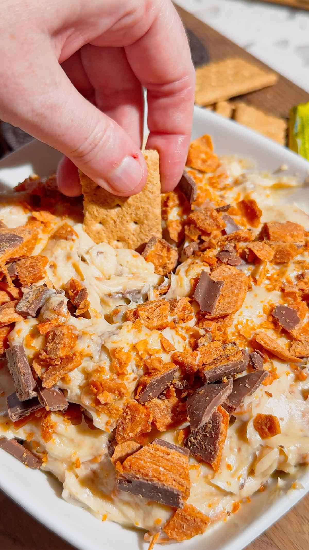 If you're looking for the ultimate no bake dessert, this Butterfinger Dip is about to become your new favorite sweet treat. Made with cream cheese, butter, brown sugar, vanilla, and plenty of chopped Butterfinger candy bars, this creamy dessert dip is perfect for parties, game day, holidays, movie nights, and potlucks. Serve it with graham crackers, vanilla wafers, pretzels, apple slices, strawberries, or cookies for an easy crowd-pleasing snack. This easy dessert dip recipe takes just 10 minutes to make with no baking required, making it ideal for last-minute entertaining. Save this Butterfinger Dip recipe for your favorite candy dessert, no bake desserts, party food ideas, easy dessert recipes, and delicious dessert dips everyone will love.