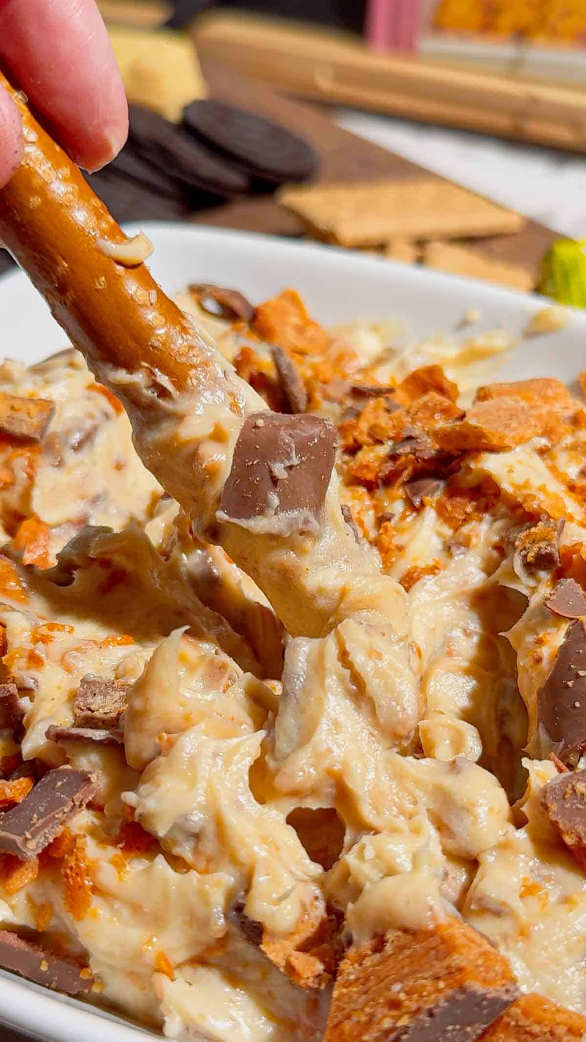If you're looking for the ultimate no bake dessert, this Butterfinger Dip is about to become your new favorite sweet treat. Made with cream cheese, butter, brown sugar, vanilla, and plenty of chopped Butterfinger candy bars, this creamy dessert dip is perfect for parties, game day, holidays, movie nights, and potlucks. Serve it with graham crackers, vanilla wafers, pretzels, apple slices, strawberries, or cookies for an easy crowd-pleasing snack. This easy dessert dip recipe takes just 10 minutes to make with no baking required, making it ideal for last-minute entertaining. Save this Butterfinger Dip recipe for your favorite candy dessert, no bake desserts, party food ideas, easy dessert recipes, and delicious dessert dips everyone will love.