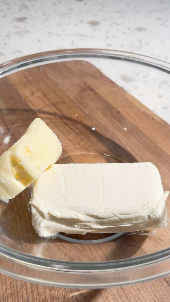 cream cheese and butter in a glass mixing bowl