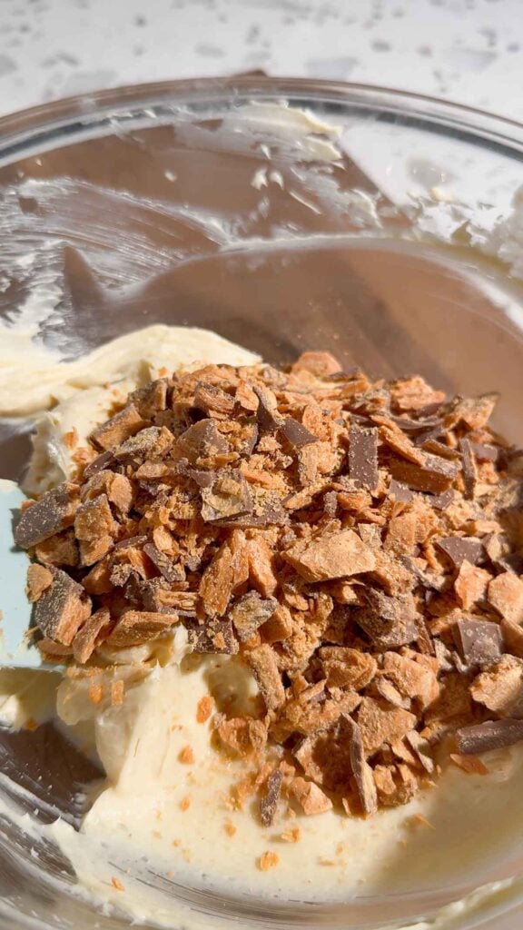 chopped butterfingers added to bowl with cream cheese mixture