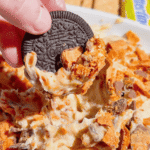 If you're looking for the ultimate no bake dessert, this Butterfinger Dip is about to become your new favorite sweet treat. Made with cream cheese, butter, brown sugar, vanilla, and plenty of chopped Butterfinger candy bars, this creamy dessert dip is perfect for parties, game day, holidays, movie nights, and potlucks. Serve it with graham crackers, vanilla wafers, pretzels, apple slices, strawberries, or cookies for an easy crowd-pleasing snack. This easy dessert dip recipe takes just 10 minutes to make with no baking required, making it ideal for last-minute entertaining. Save this Butterfinger Dip recipe for your favorite candy dessert, no bake desserts, party food ideas, easy dessert recipes, and delicious dessert dips everyone will love.