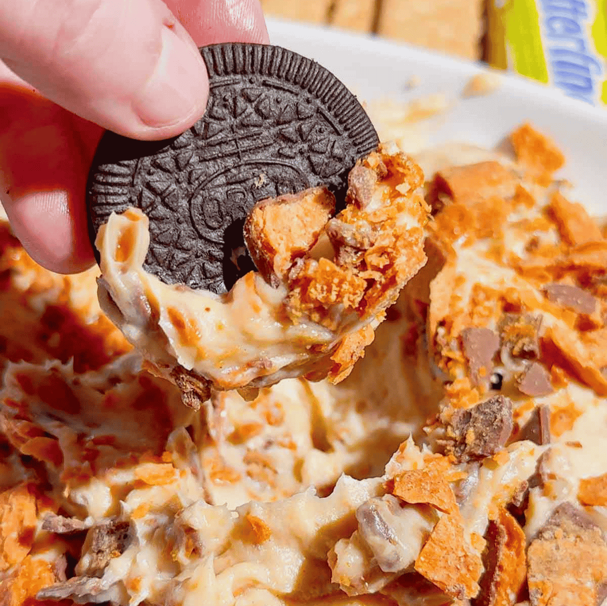 If you're looking for the ultimate no bake dessert, this Butterfinger Dip is about to become your new favorite sweet treat. Made with cream cheese, butter, brown sugar, vanilla, and plenty of chopped Butterfinger candy bars, this creamy dessert dip is perfect for parties, game day, holidays, movie nights, and potlucks. Serve it with graham crackers, vanilla wafers, pretzels, apple slices, strawberries, or cookies for an easy crowd-pleasing snack. This easy dessert dip recipe takes just 10 minutes to make with no baking required, making it ideal for last-minute entertaining. Save this Butterfinger Dip recipe for your favorite candy dessert, no bake desserts, party food ideas, easy dessert recipes, and delicious dessert dips everyone will love.