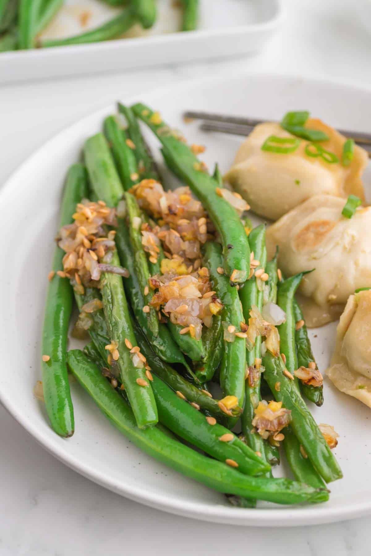 Looking for the best Chinese Green Beans recipe? These easy Asian Green Beans are crisp-tender, packed with garlic, ginger, shallots, and a savory touch of mirin for an irresistible restaurant-style side dish. If you've been searching for Chinese Green Bean Recipes, Garlic Green Beans, Stir Fry Green Beans, Green Bean Side Dish, Easy Vegetable Side Dishes, Healthy Green Bean Recipes, Asian Side Dishes, or How to Cook Fresh Green Beans, this simple recipe is a must-try. Perfect for busy weeknights, holiday dinners, or serving with your favorite chicken, beef, pork, or rice dishes, these flavorful sesame green beans come together in under 30 minutes and taste even better than takeout. Save this easy green bean recipe for your next family meal!