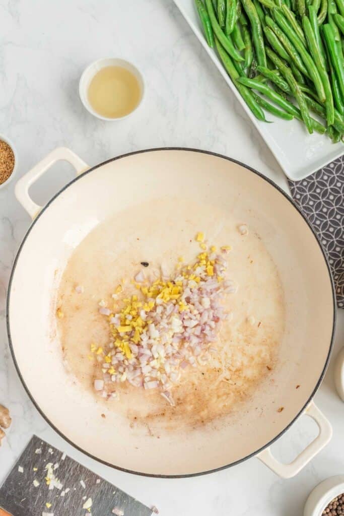 shallots, garlic and ginger added to a skillet