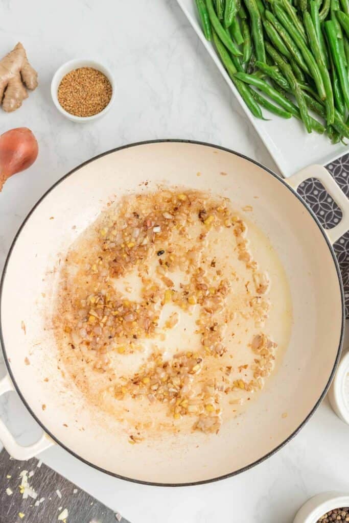 shallots, garlic and ginger cooking in a skillet