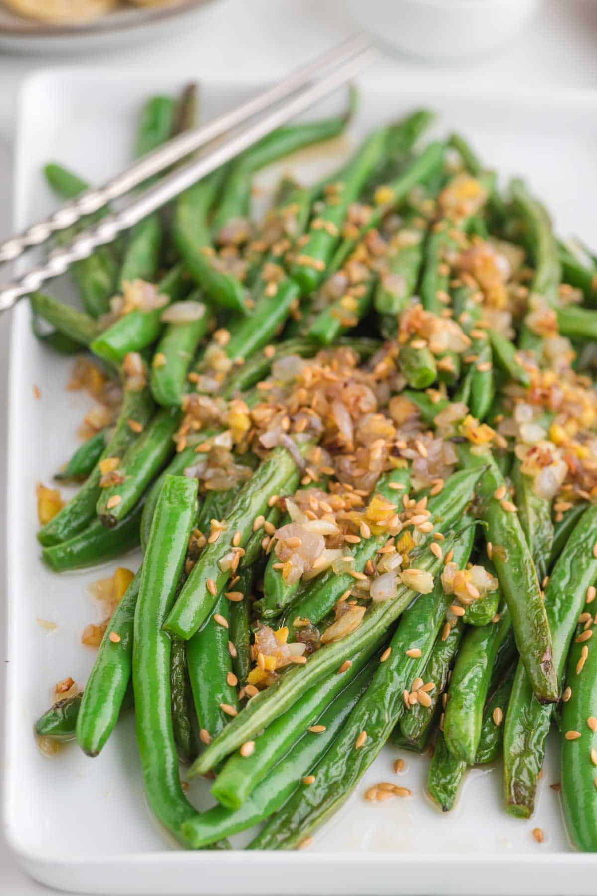 Looking for the best Chinese Green Beans recipe? These easy Asian Green Beans are crisp-tender, packed with garlic, ginger, shallots, and a savory touch of mirin for an irresistible restaurant-style side dish. If you've been searching for Chinese Green Bean Recipes, Garlic Green Beans, Stir Fry Green Beans, Green Bean Side Dish, Easy Vegetable Side Dishes, Healthy Green Bean Recipes, Asian Side Dishes, or How to Cook Fresh Green Beans, this simple recipe is a must-try. Perfect for busy weeknights, holiday dinners, or serving with your favorite chicken, beef, pork, or rice dishes, these flavorful sesame green beans come together in under 30 minutes and taste even better than takeout. Save this easy green bean recipe for your next family meal!