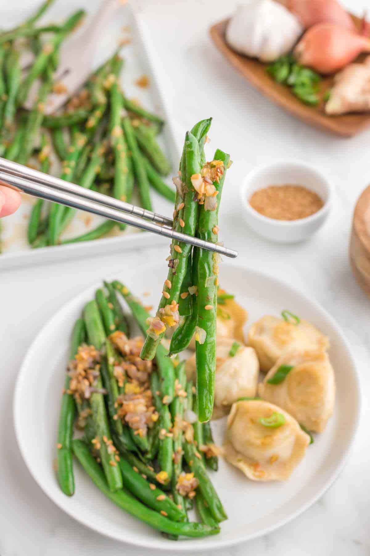 Looking for the best Chinese Green Beans recipe? These easy Asian Green Beans are crisp-tender, packed with garlic, ginger, shallots, and a savory touch of mirin for an irresistible restaurant-style side dish. If you've been searching for Chinese Green Bean Recipes, Garlic Green Beans, Stir Fry Green Beans, Green Bean Side Dish, Easy Vegetable Side Dishes, Healthy Green Bean Recipes, Asian Side Dishes, or How to Cook Fresh Green Beans, this simple recipe is a must-try. Perfect for busy weeknights, holiday dinners, or serving with your favorite chicken, beef, pork, or rice dishes, these flavorful sesame green beans come together in under 30 minutes and taste even better than takeout. Save this easy green bean recipe for your next family meal!