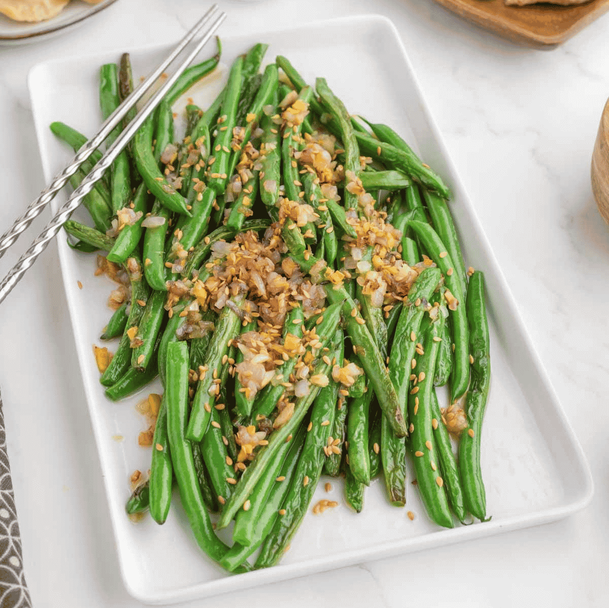 Looking for the best Chinese Green Beans recipe? These easy Asian Green Beans are crisp-tender, packed with garlic, ginger, shallots, and a savory touch of mirin for an irresistible restaurant-style side dish. If you've been searching for Chinese Green Bean Recipes, Garlic Green Beans, Stir Fry Green Beans, Green Bean Side Dish, Easy Vegetable Side Dishes, Healthy Green Bean Recipes, Asian Side Dishes, or How to Cook Fresh Green Beans, this simple recipe is a must-try. Perfect for busy weeknights, holiday dinners, or serving with your favorite chicken, beef, pork, or rice dishes, these flavorful sesame green beans come together in under 30 minutes and taste even better than takeout. Save this easy green bean recipe for your next family meal!