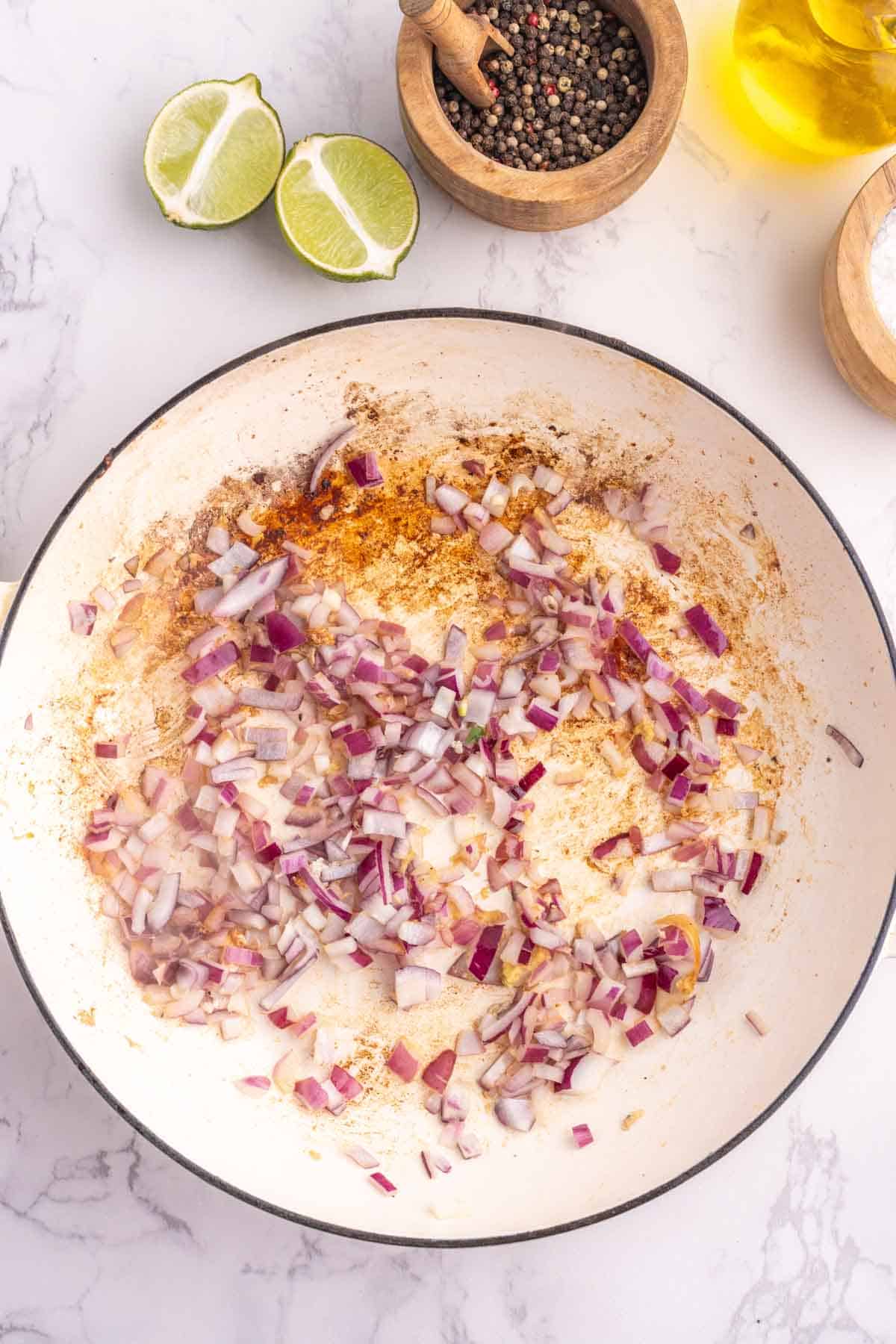 diced onion, garlic and ginger cooking in a skillet