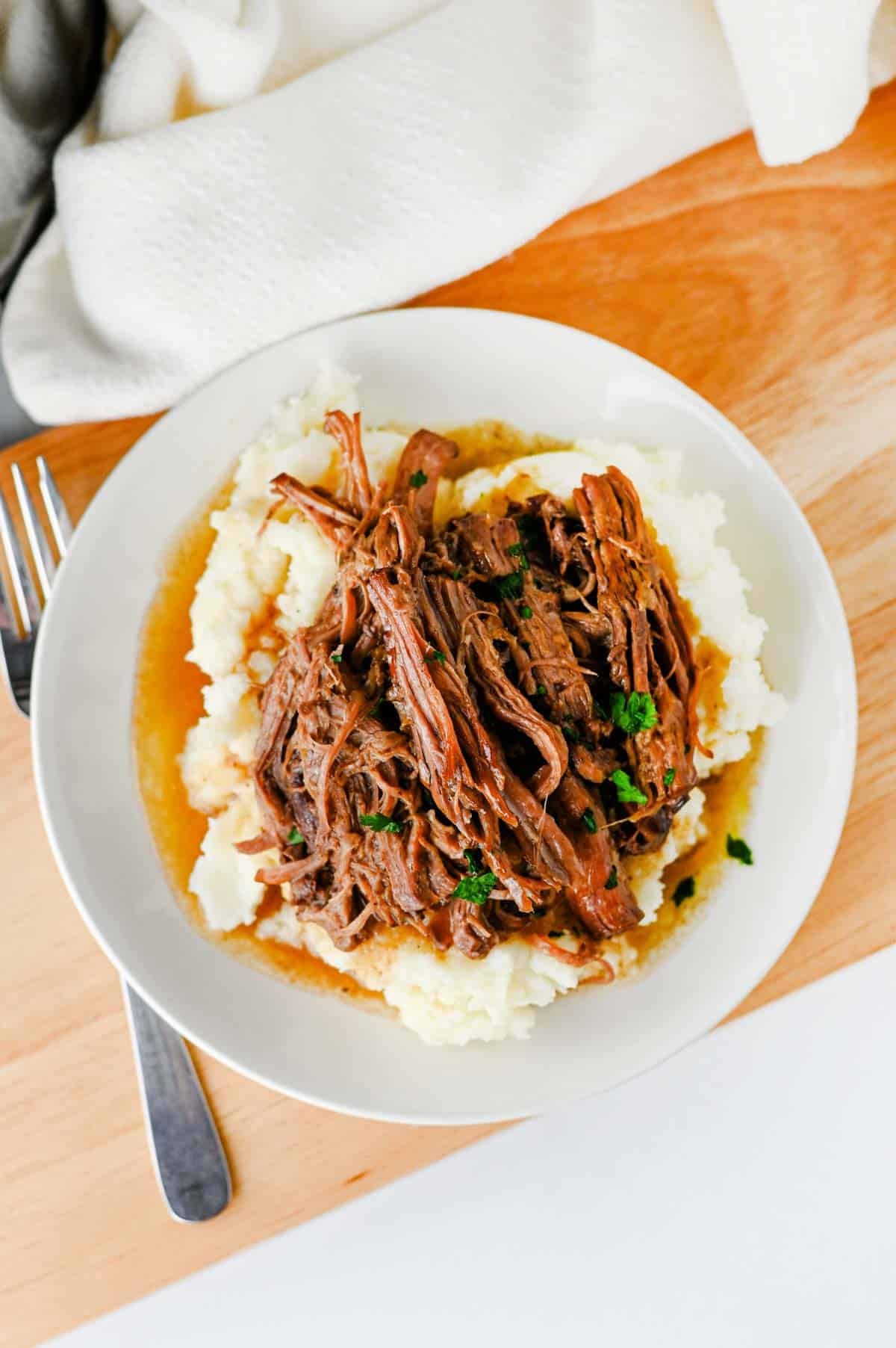 Looking for the best Crock Pot Mississippi Pot Roast recipe? This easy slow cooker Mississippi pot roast is made with chuck roast, ranch seasoning, au jus gravy mix, butter, and pepperoncini peppers for a rich, tender, melt-in-your-mouth dinner the whole family will love. Perfect for easy crock pot dinners, slow cooker beef recipes, comfort food recipes, Sunday dinner ideas, and busy weeknight meals, this recipe requires only 10 minutes of prep before the crock pot does all the work. Serve it over creamy mashed potatoes, rice, or egg noodles for a hearty meal that's packed with flavor. Save this simple Mississippi pot roast recipe for your next cozy family dinner or meal prep favorite!