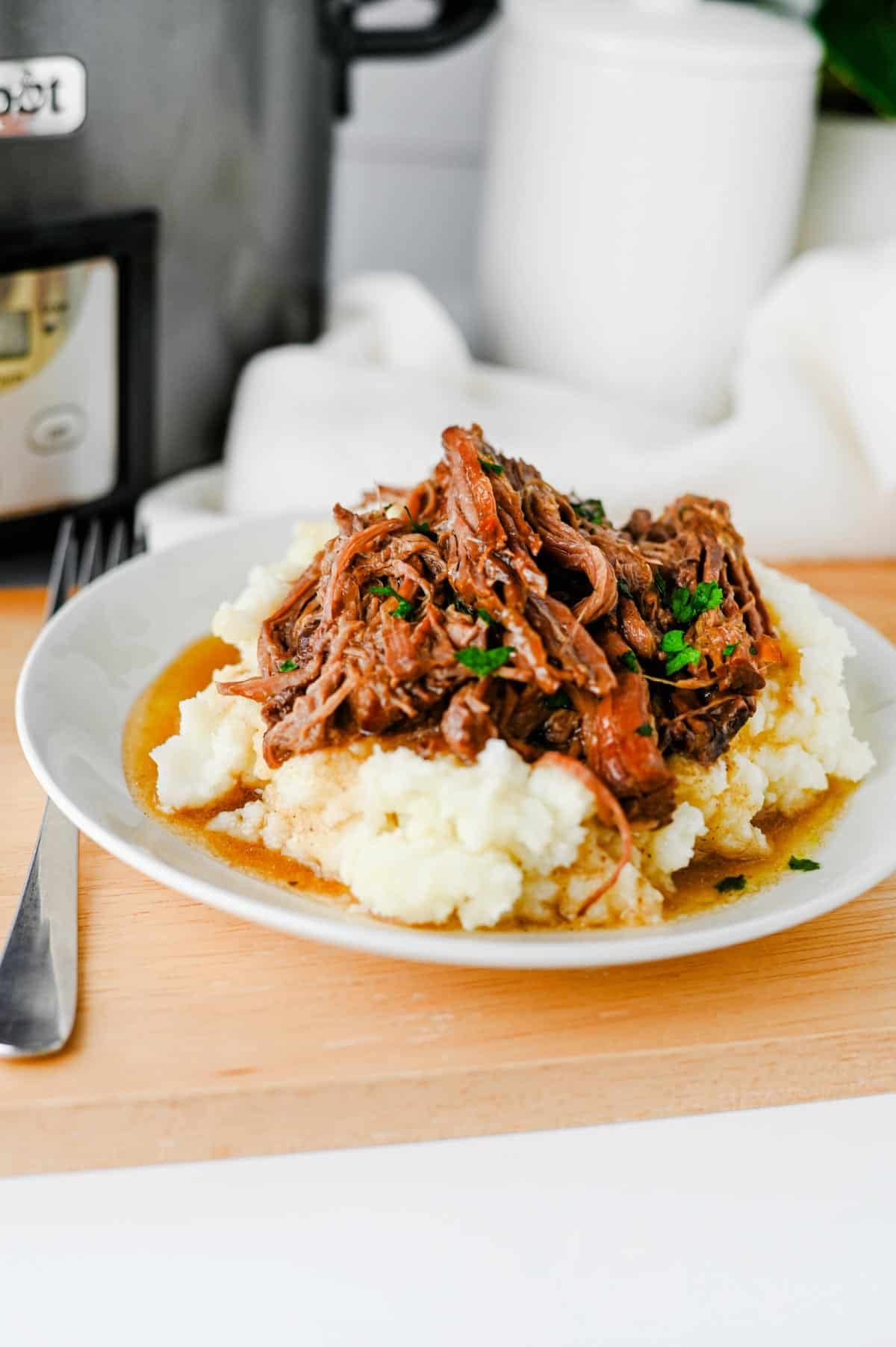 Looking for the best Crock Pot Mississippi Pot Roast recipe? This easy slow cooker Mississippi pot roast is made with chuck roast, ranch seasoning, au jus gravy mix, butter, and pepperoncini peppers for a rich, tender, melt-in-your-mouth dinner the whole family will love. Perfect for easy crock pot dinners, slow cooker beef recipes, comfort food recipes, Sunday dinner ideas, and busy weeknight meals, this recipe requires only 10 minutes of prep before the crock pot does all the work. Serve it over creamy mashed potatoes, rice, or egg noodles for a hearty meal that's packed with flavor. Save this simple Mississippi pot roast recipe for your next cozy family dinner or meal prep favorite!