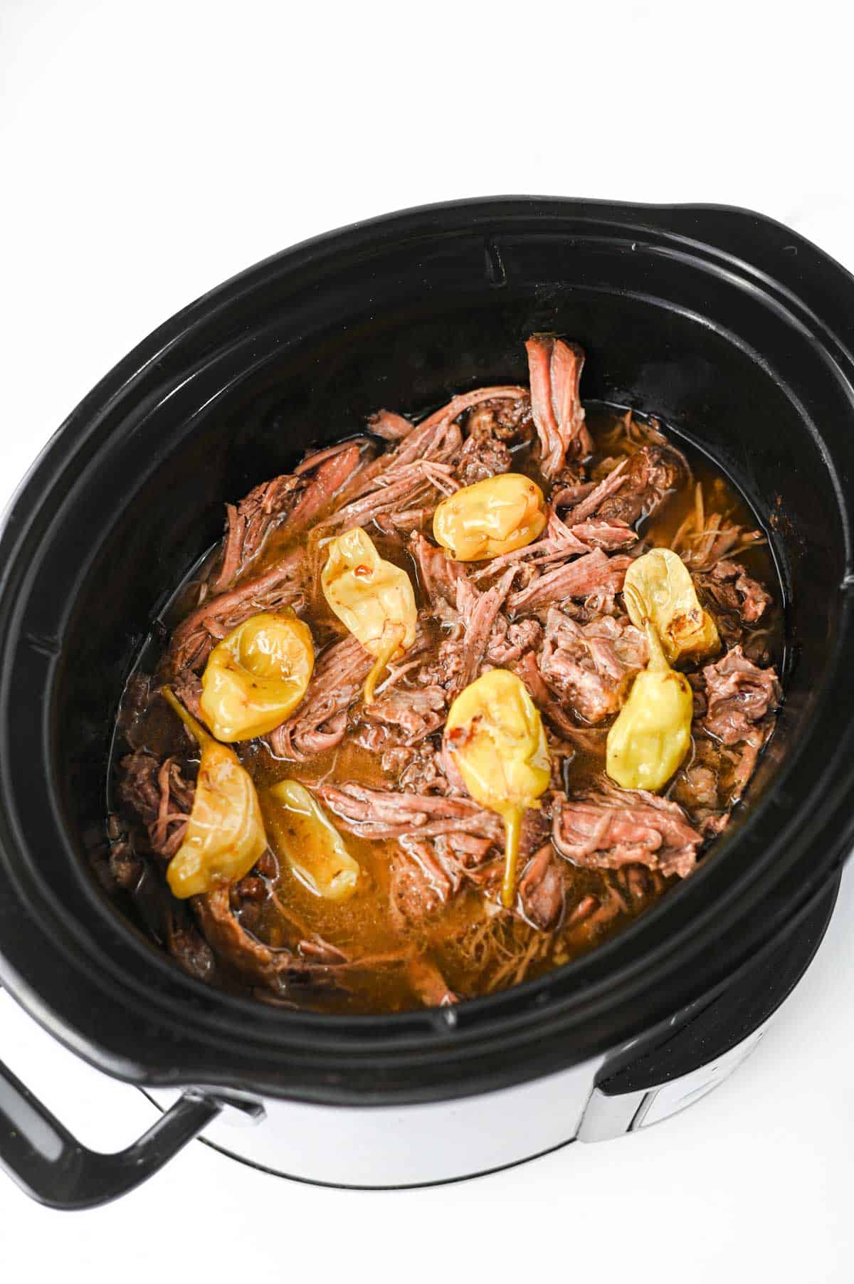 Looking for the best Crock Pot Mississippi Pot Roast recipe? This easy slow cooker Mississippi pot roast is made with chuck roast, ranch seasoning, au jus gravy mix, butter, and pepperoncini peppers for a rich, tender, melt-in-your-mouth dinner the whole family will love. Perfect for easy crock pot dinners, slow cooker beef recipes, comfort food recipes, Sunday dinner ideas, and busy weeknight meals, this recipe requires only 10 minutes of prep before the crock pot does all the work. Serve it over creamy mashed potatoes, rice, or egg noodles for a hearty meal that's packed with flavor. Save this simple Mississippi pot roast recipe for your next cozy family dinner or meal prep favorite!