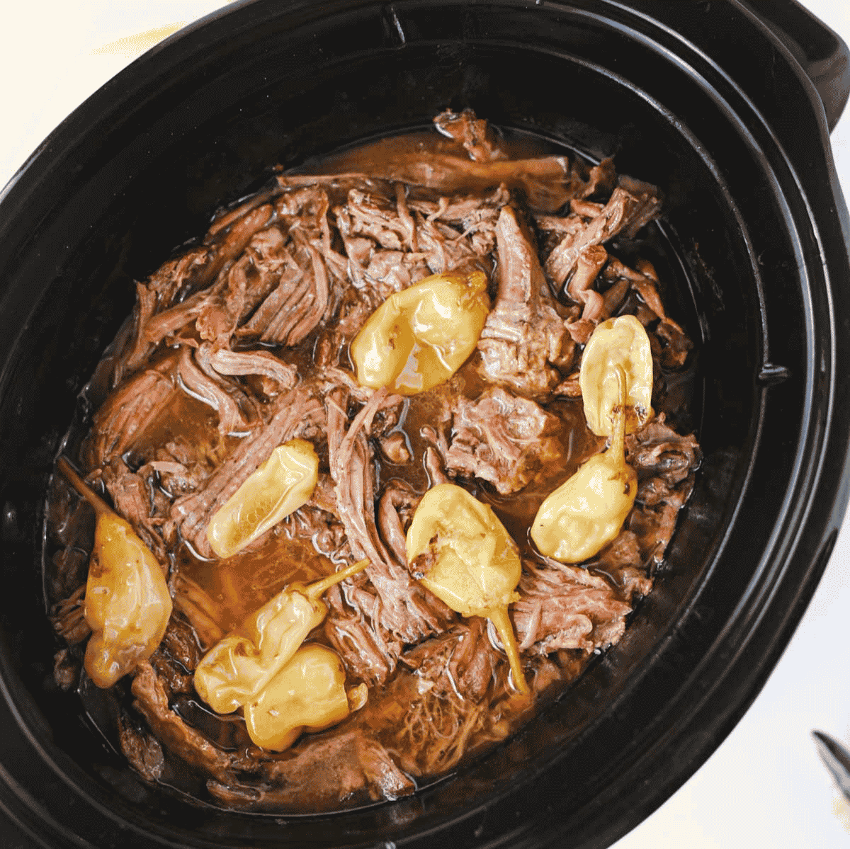 Looking for the best Crock Pot Mississippi Pot Roast recipe? This easy slow cooker Mississippi pot roast is made with chuck roast, ranch seasoning, au jus gravy mix, butter, and pepperoncini peppers for a rich, tender, melt-in-your-mouth dinner the whole family will love. Perfect for easy crock pot dinners, slow cooker beef recipes, comfort food recipes, Sunday dinner ideas, and busy weeknight meals, this recipe requires only 10 minutes of prep before the crock pot does all the work. Serve it over creamy mashed potatoes, rice, or egg noodles for a hearty meal that's packed with flavor. Save this simple Mississippi pot roast recipe for your next cozy family dinner or meal prep favorite!