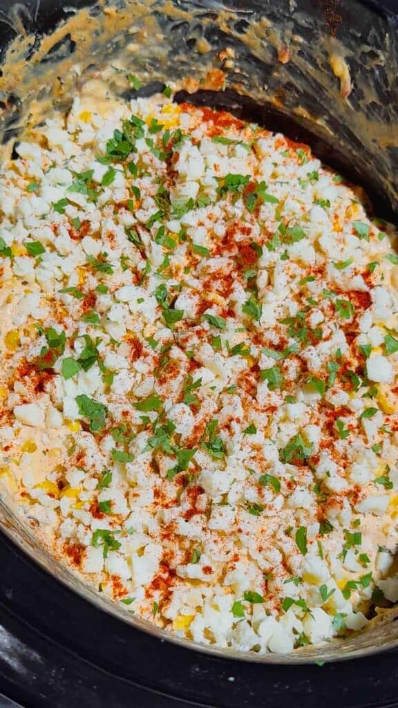 Looking for the ultimate Crock Pot Street Corn Dip recipe? This creamy Slow Cooker Mexican Street Corn Dip is loaded with frozen corn, cream cheese, pepper jack, sour cream, Cotija cheese, cilantro, lime, and smoky spices for an irresistible appetizer everyone will love. Perfect for Crockpot Dip Recipes, Game Day Food, Football Party Food, Cinco de Mayo Recipes, Easy Party Dips, Corn Dip Recipes, Slow Cooker Appetizers, Hot Cheese Dip, and Mexican Appetizers. Serve it with tortilla chips, crackers, or fresh veggies for an easy crowd-pleasing snack. Whether you're hosting a party, potluck, BBQ, or holiday gathering, this cheesy street corn dip is a simple make-ahead recipe that's guaranteed to disappear fast.