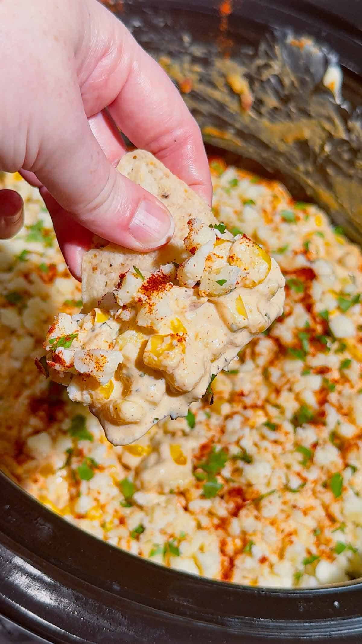 Looking for the ultimate Crock Pot Street Corn Dip recipe? This creamy Slow Cooker Mexican Street Corn Dip is loaded with frozen corn, cream cheese, pepper jack, sour cream, Cotija cheese, cilantro, lime, and smoky spices for an irresistible appetizer everyone will love. Perfect for Crockpot Dip Recipes, Game Day Food, Football Party Food, Cinco de Mayo Recipes, Easy Party Dips, Corn Dip Recipes, Slow Cooker Appetizers, Hot Cheese Dip, and Mexican Appetizers. Serve it with tortilla chips, crackers, or fresh veggies for an easy crowd-pleasing snack. Whether you're hosting a party, potluck, BBQ, or holiday gathering, this cheesy street corn dip is a simple make-ahead recipe that's guaranteed to disappear fast.