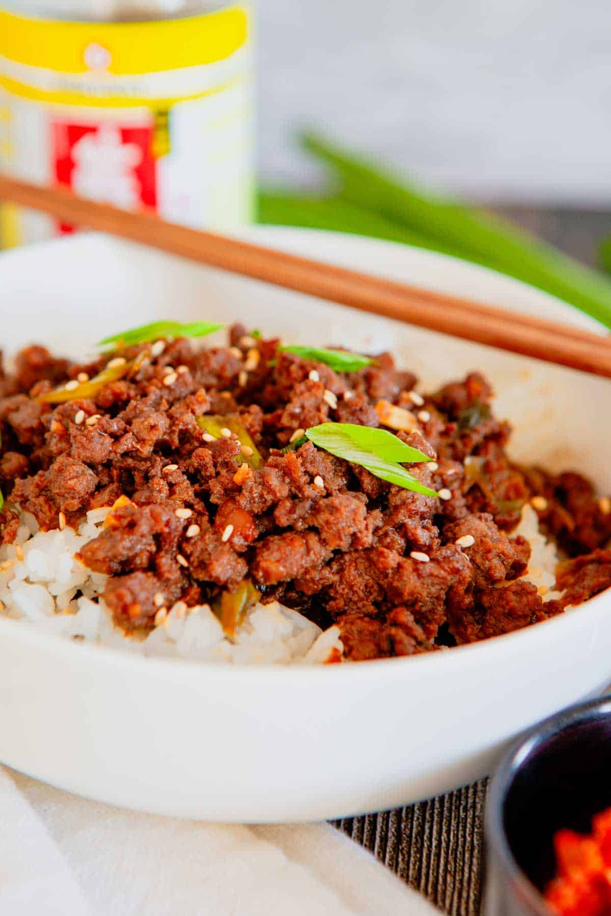 Craving a fast dinner that's packed with flavor? These Korean Ground Beef Bowls are the ultimate weeknight meal, made with tender ground beef coated in a sweet, savory, and slightly spicy Korean-inspired sauce with soy sauce, brown sugar, garlic, ginger, sesame oil, and gochujang. Served over fluffy rice and topped with green onions and sesame seeds, this easy Ground Beef Bowl is ready in just 15 minutes. Perfect for Easy Ground Beef Recipes, Korean Beef Rice Bowls, Ground Beef Dinner Ideas, Quick Family Meals, Asian Inspired Recipes, Weeknight Dinner Recipes, Meal Prep Bowls, Rice Bowl Recipes, Ground Beef and Rice, and Budget Friendly Dinners, this simple recipe is one you'll make again and again.
